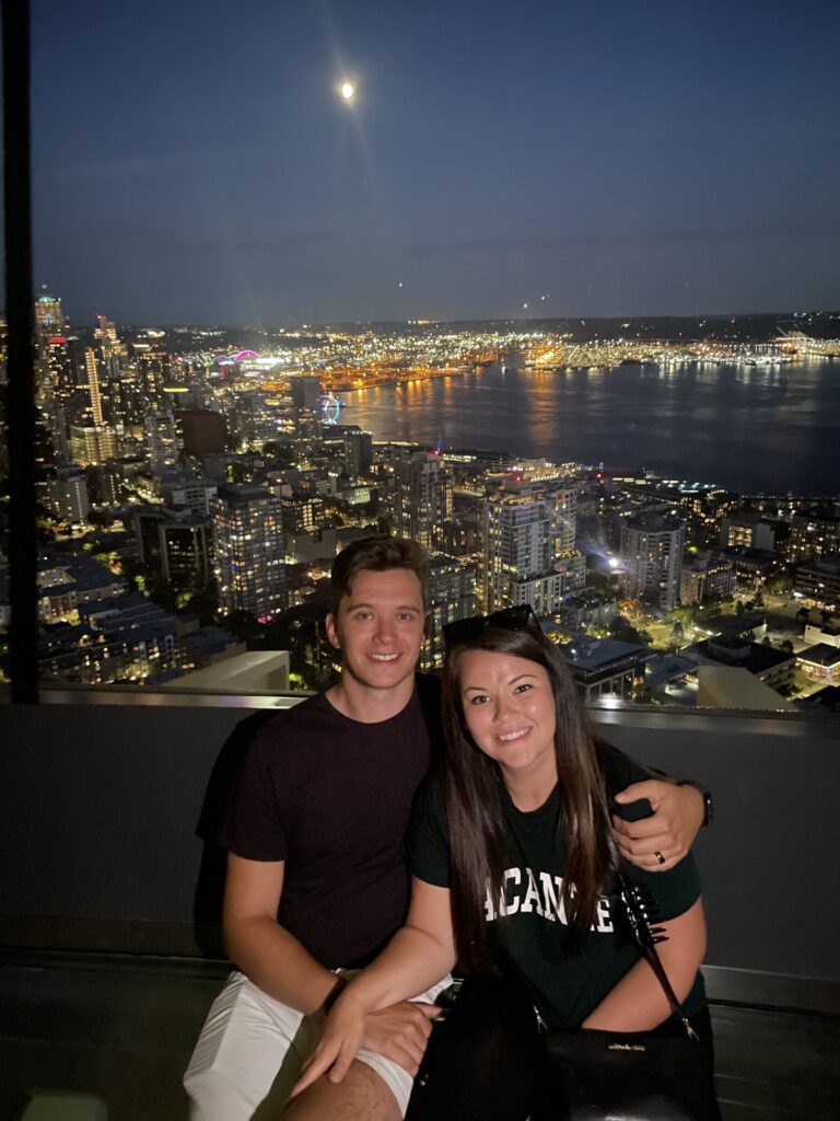 Ethan and Emily at the Space Needle with Seattle skyline