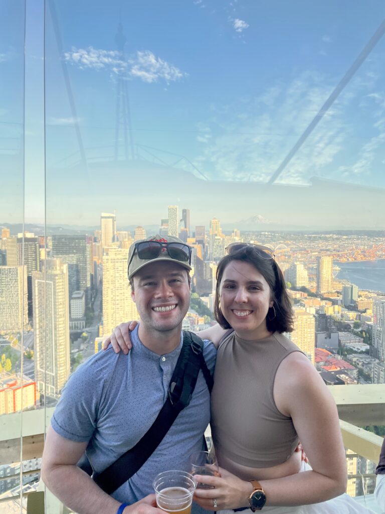 Jacquie and Alex at Space Needle with Mount Rainier in the background