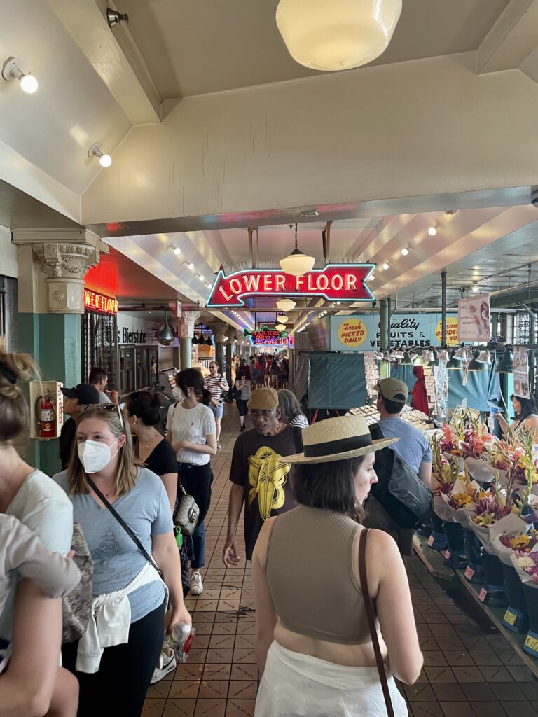 Jacquie walking through Pike Place Market