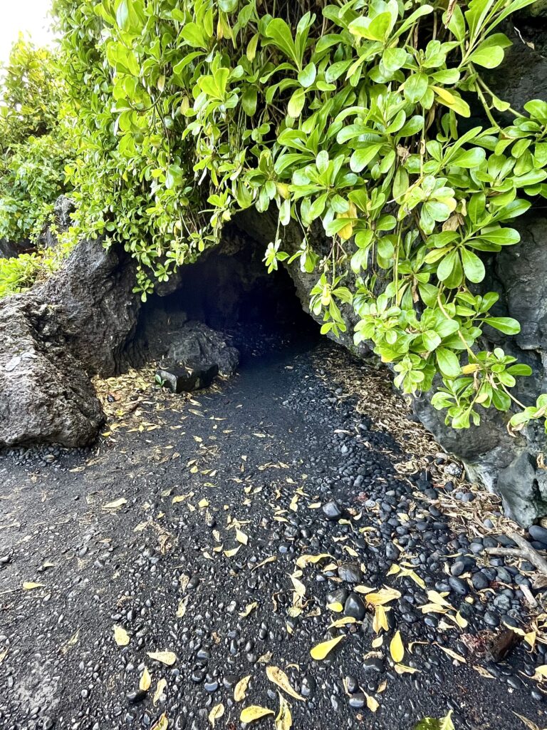 Entrance to the lava tube to the right of black sand beach