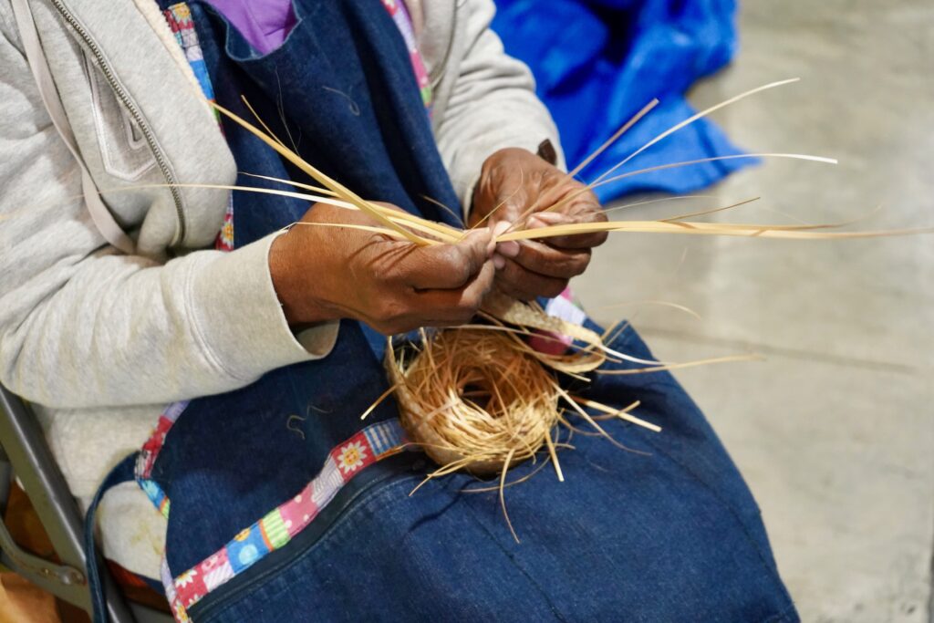 Woman practicing traditional straw weaving