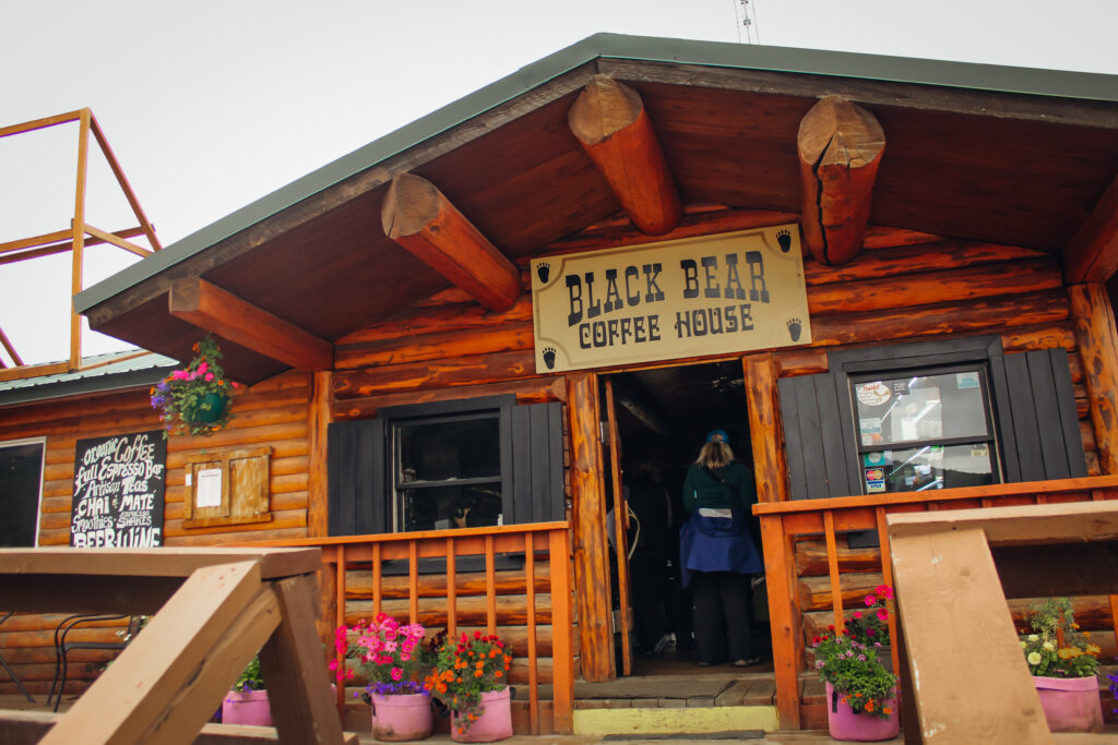 Exterior of a log cabin coffee shop.