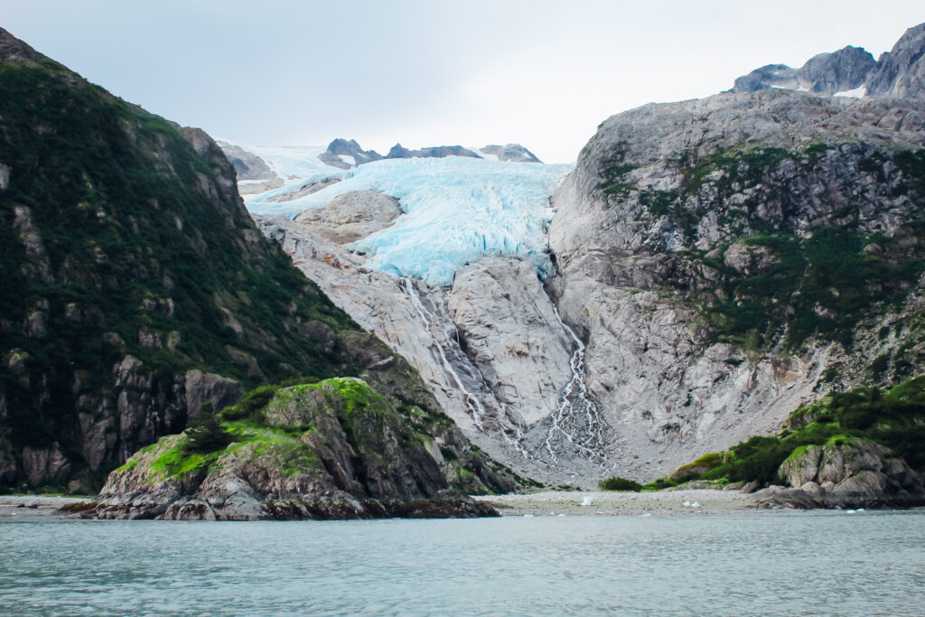 A glacier poking between two mountians