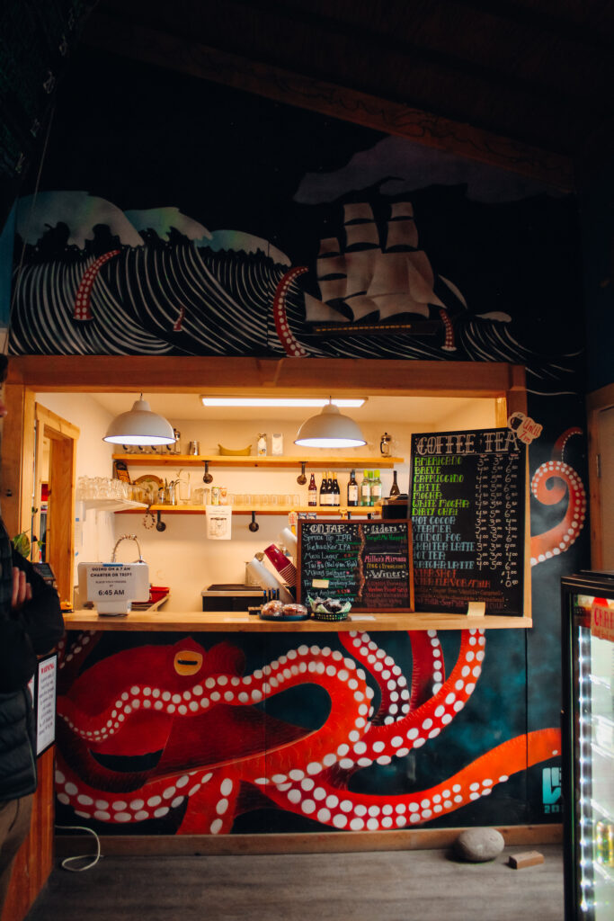 A coffee counter with an octopus mural around it