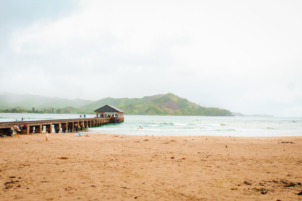 A pier with a cloudy bay behind it.