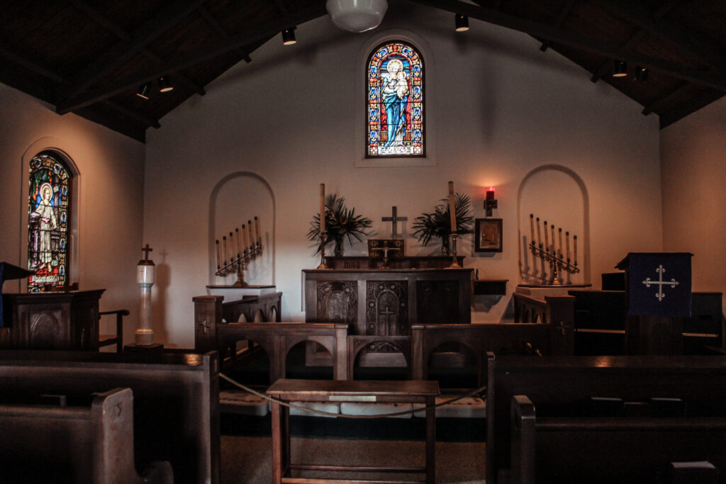 Interior of the church with an alter and stianed glass