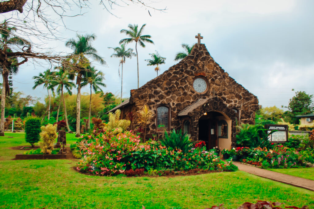 Small stone church with palm trees in the background