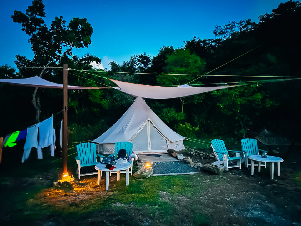 Campsite in the evening with chairs and a fire