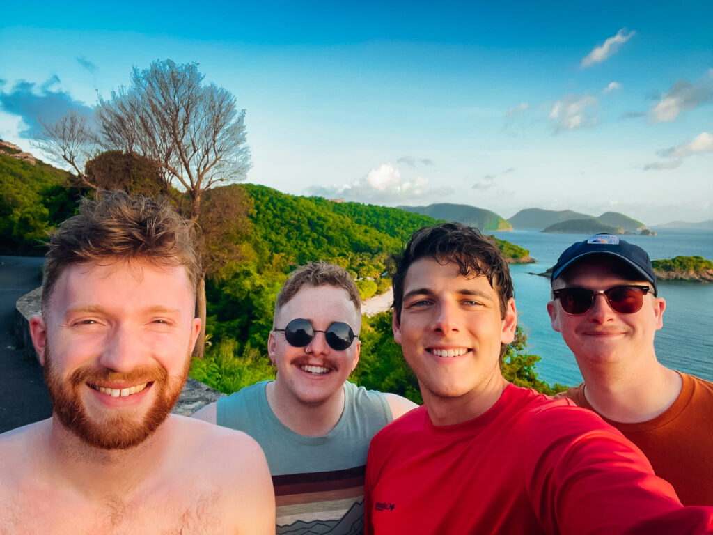 A group of four men in front of a vista view.