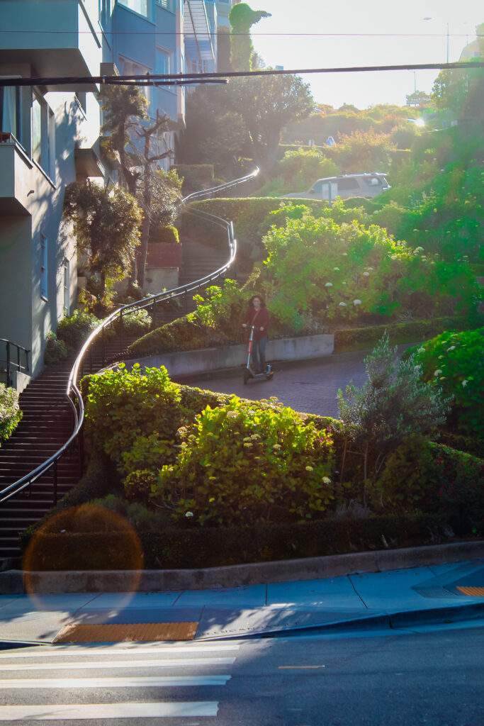 Woman riding scooter down Lombard Street